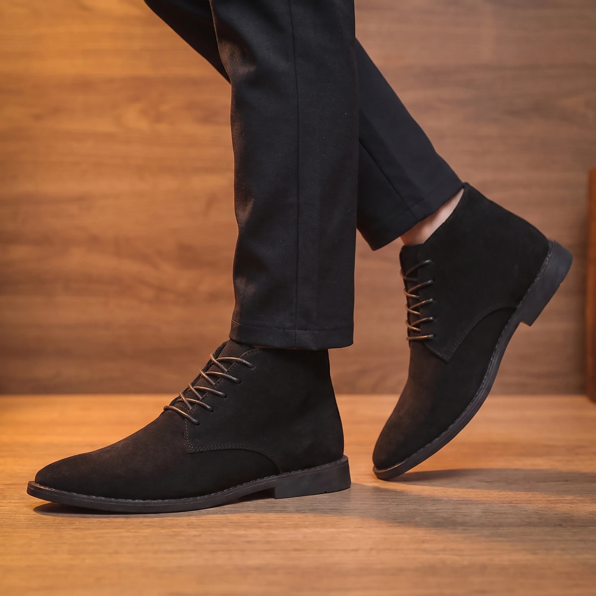 Man wearing black desert boots mid-stride
