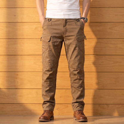 Multipocket cotton cargo pants in brown, worn front view against a warm wood wall