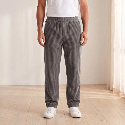 Men's grey wide wale corduroy loose straight trousers with elastic waist, worn
