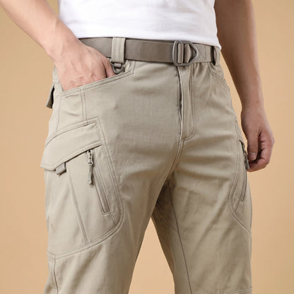 Man wearing stretch cargo trousers, waist view with hand in a cargo pocket