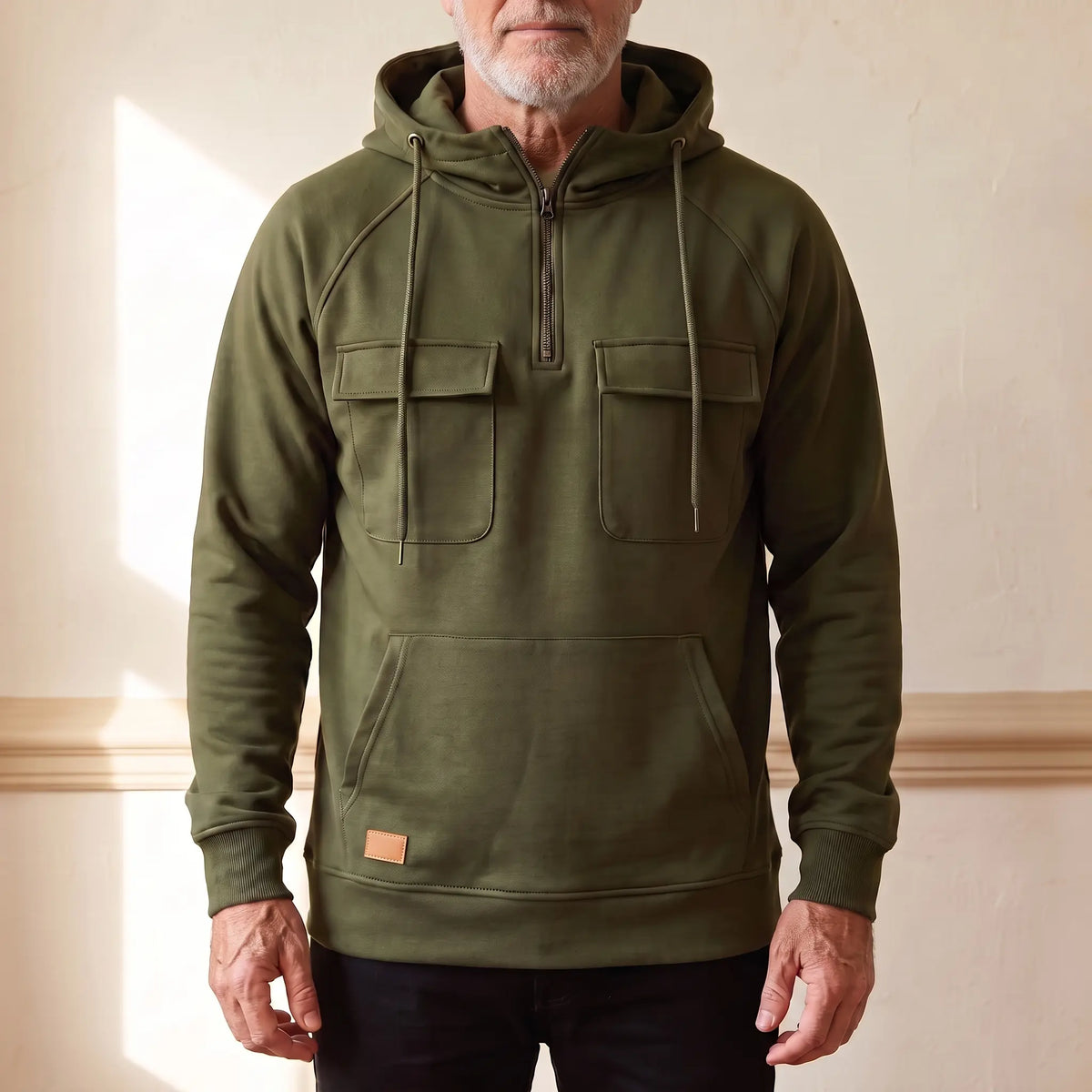 Men's olive green hooded anorak sweatshirt with half zip and twin chest flap pockets, worn