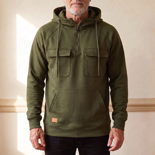 Men's olive green hooded anorak sweatshirt with half zip and twin chest flap pockets, worn