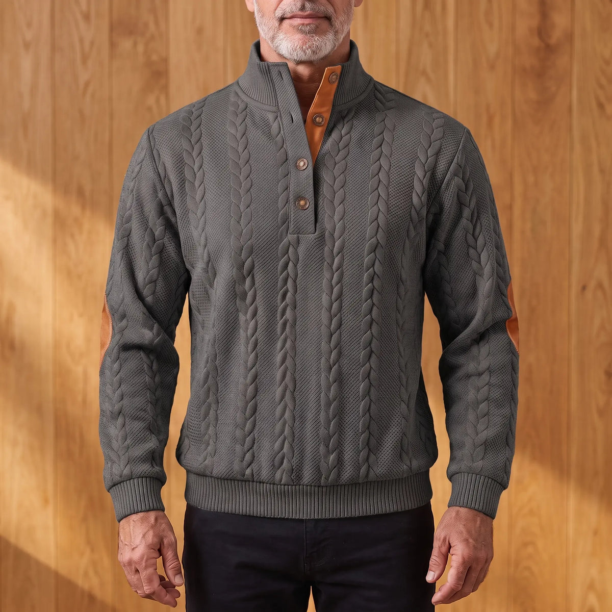 Men's charcoal grey cable knit henley sweater with stand collar, three-button placket and tan elbow patches, worn