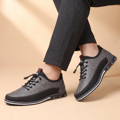SMART CASUAL SNEAKERS worn by a man in dark trousers, crossed-ankles view