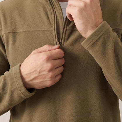 Man pulling up the short zip on the yellow brown fleece pullover, close chest view