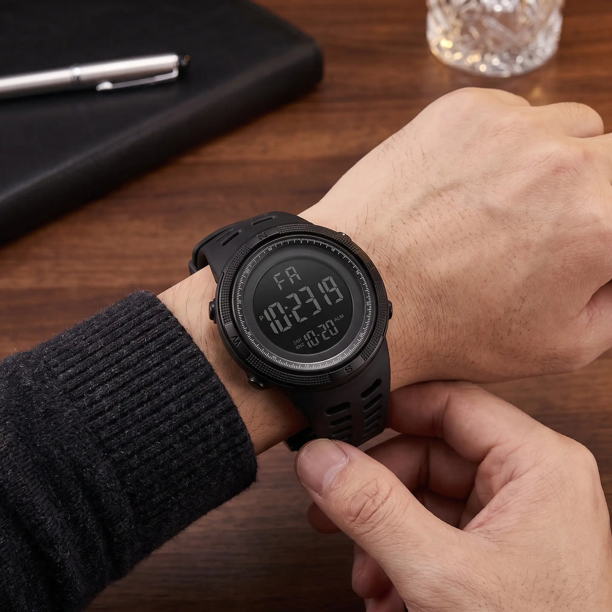 Man fastening the BACKLIT DIGITAL WATCH in black on his wrist