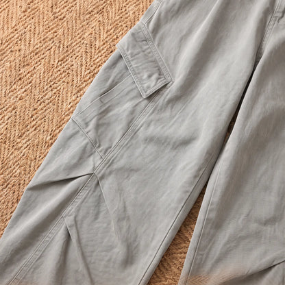 Close-up of the grey baggy cargo trousers flap cargo pocket and knee seams