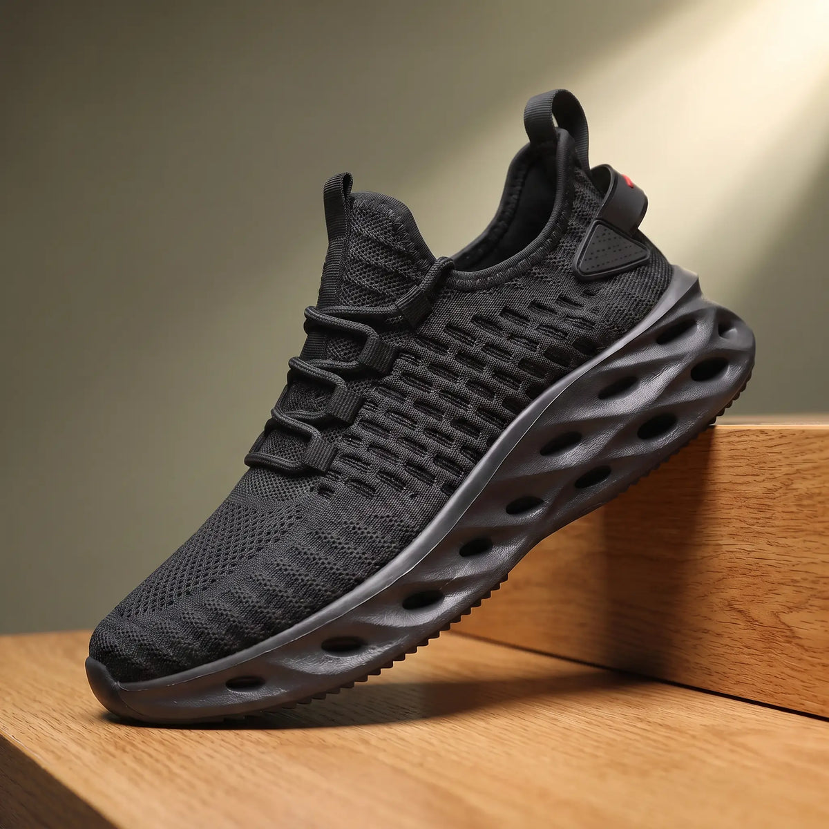 Black knit running sneakers with a thick blade cutout sole