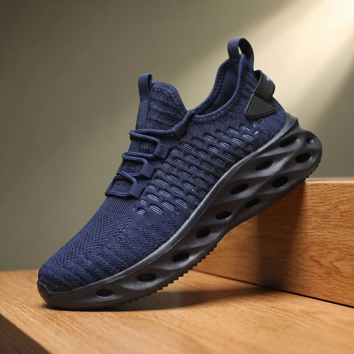 Navy blue knit running sneakers with a thick blade cutout sole
