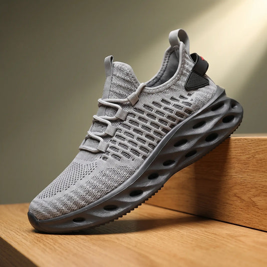 Grey knit running sneakers with a thick blade cutout sole