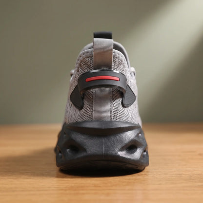 Rear close up of grey knit sneakers showing the heel clip and blade sole