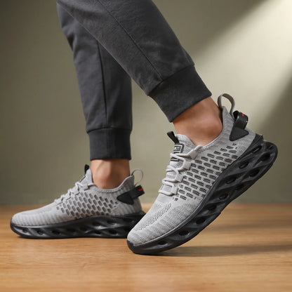 Man wearing grey knit blade sole sneakers with dark grey joggers