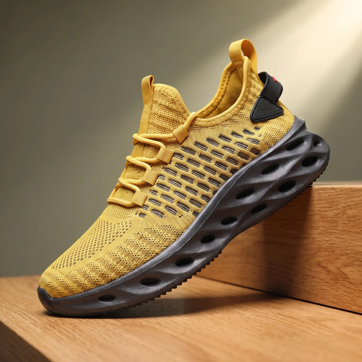 Yellow knit running sneakers with a thick blade cutout sole