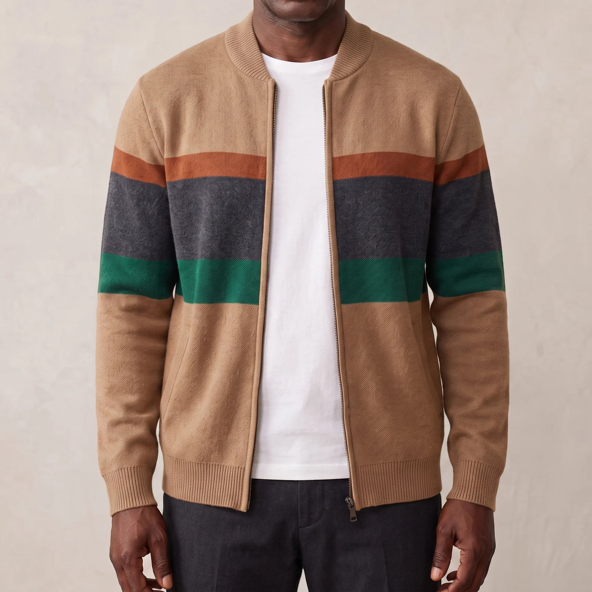 Khaki men's knit zip cardigan with rust, grey and green chest stripes and baseball collar, worn open