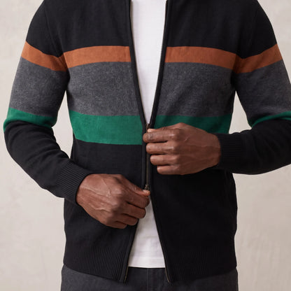 Man zipping up the green block stripe knit cardigan over a white tee
