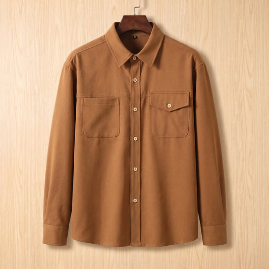 Boxy Cotton Overshirt in brown, a loose fit utility overshirt with asymmetric chest pockets on a wooden hanger