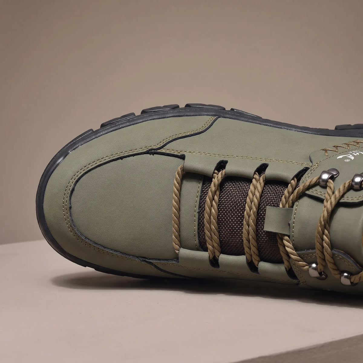 Close detail of BRAIDED CORD BOOTS showing the braided cord lacing and metal eyelets