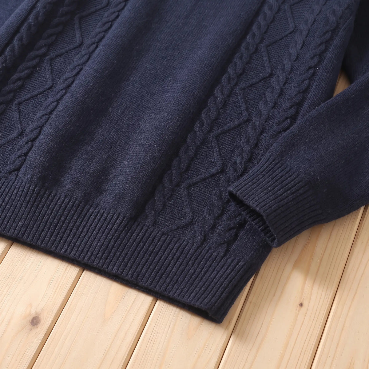 Close up of the CABLE PANEL SWEATER cable knit and ribbed hem