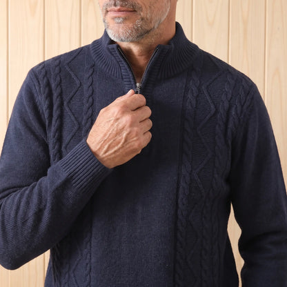 Man zipping up the CABLE PANEL SWEATER in navy blue