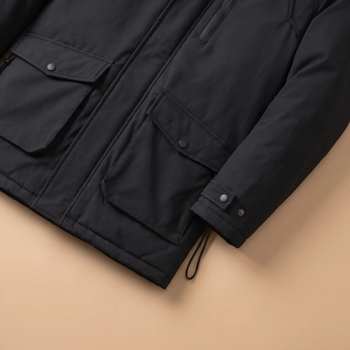 Flap cargo pockets, snap cuff and drawcord hem on a black cargo pocket parka for men