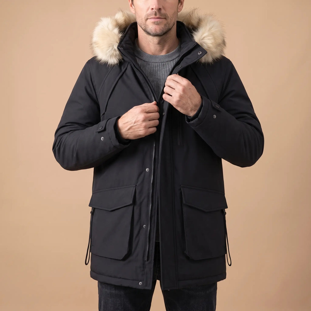 Man zipping up a black cargo pocket parka over a grey knit