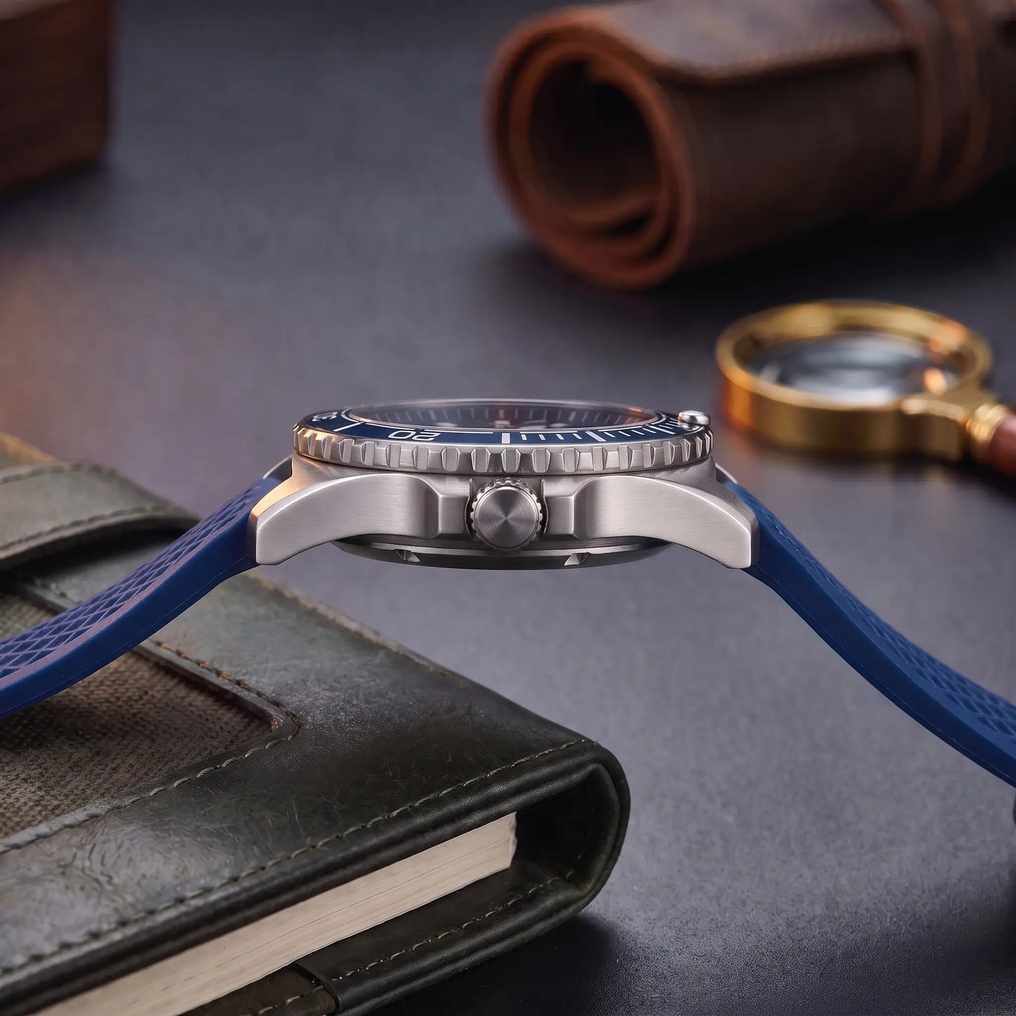 CERAMIC BEZEL WATCH case profile - screw-down crown, crown guards and textured blue rubber strap