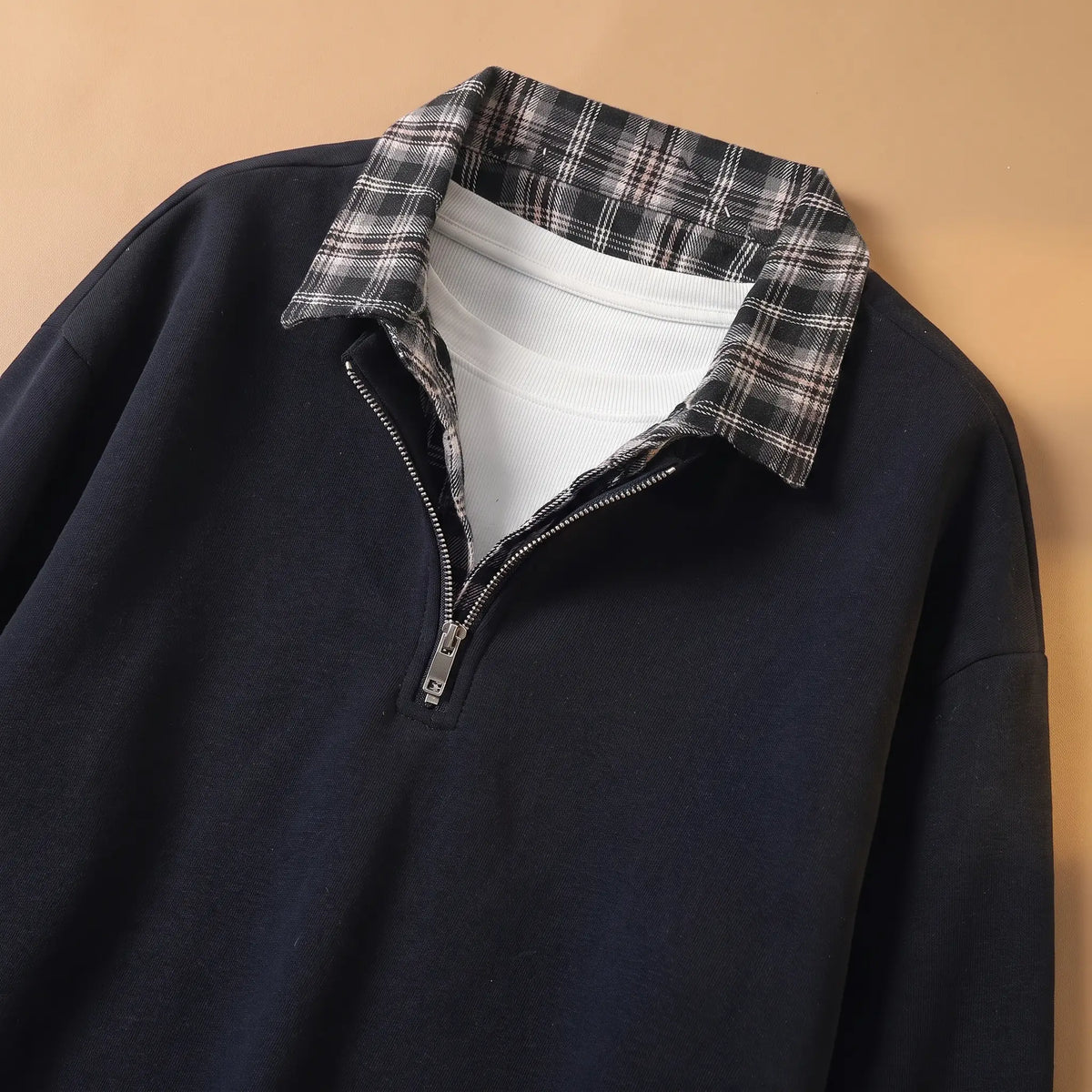 Close-up of men's navy blue sweatshirt check shirt collar and metal half zip