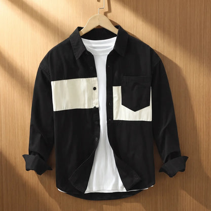 Black chest band shirt for men with cream patchwork panels on a wooden hanger