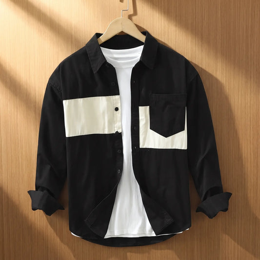 Black chest band shirt for men with cream patchwork panels on a wooden hanger