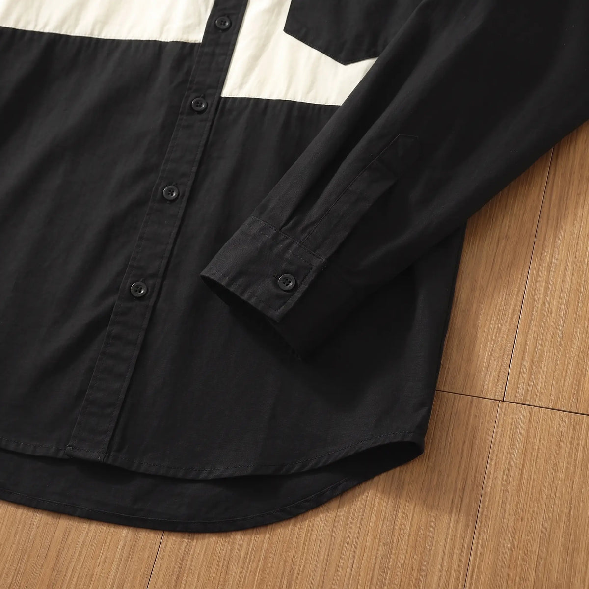 Button cuff and curved hem on a black chest band cotton shirt for men