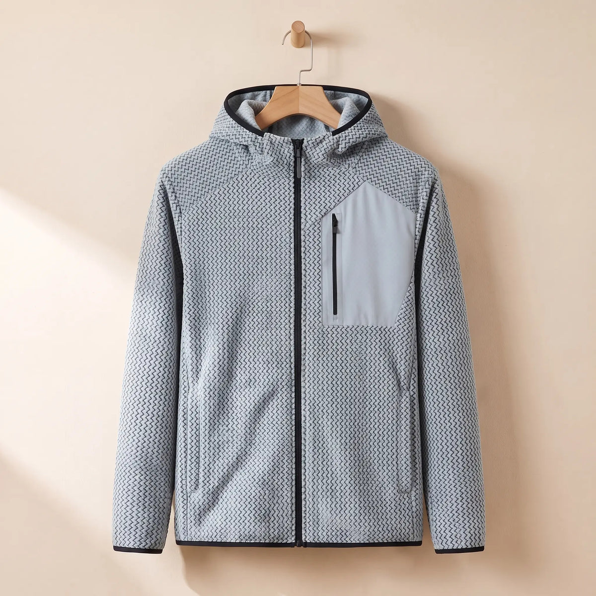 Men's light grey chevron knit hooded zip jacket on a wooden hanger