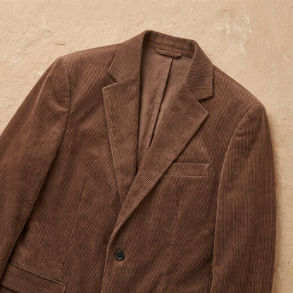 Close-up of brown corduroy blazer notch lapels and button closure