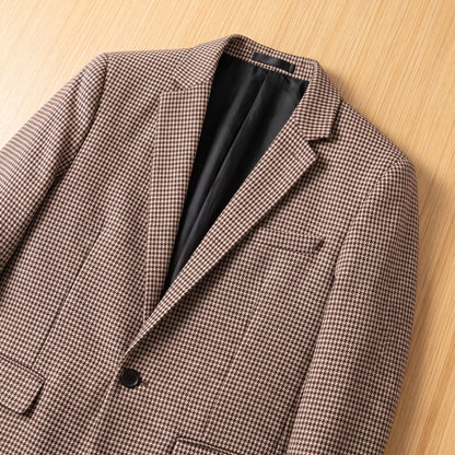 Close-up of brown houndstooth blazer lapels, chest pocket and button
