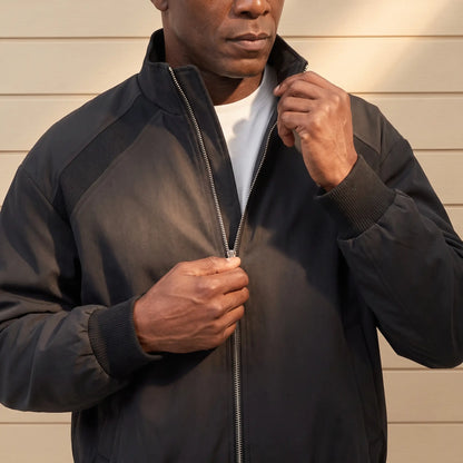 Man zipping up the CLASSIC ZIP BOMBER in black