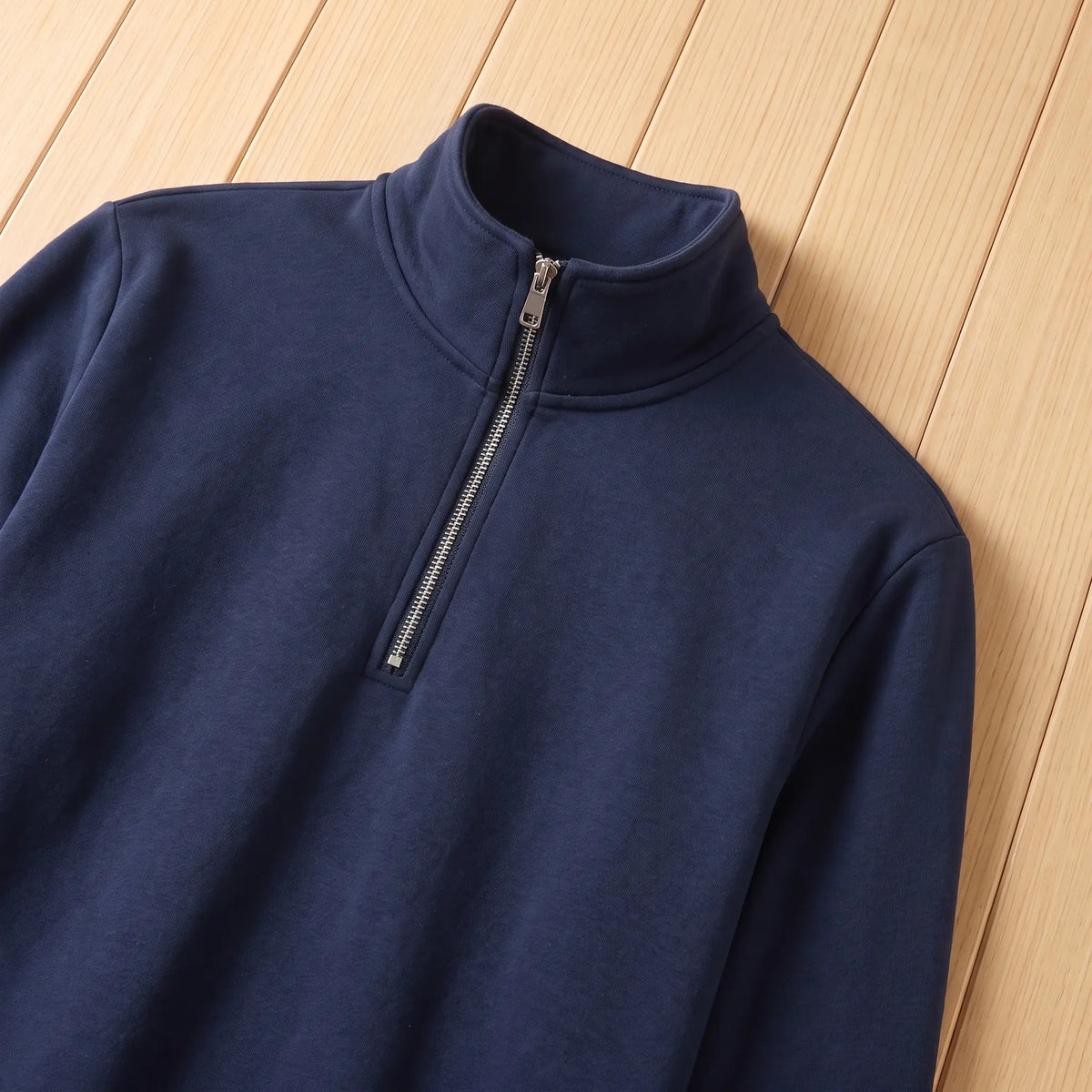 Close up of the stand collar and silver half zip on the navy blue classic zip neck sweatshirt