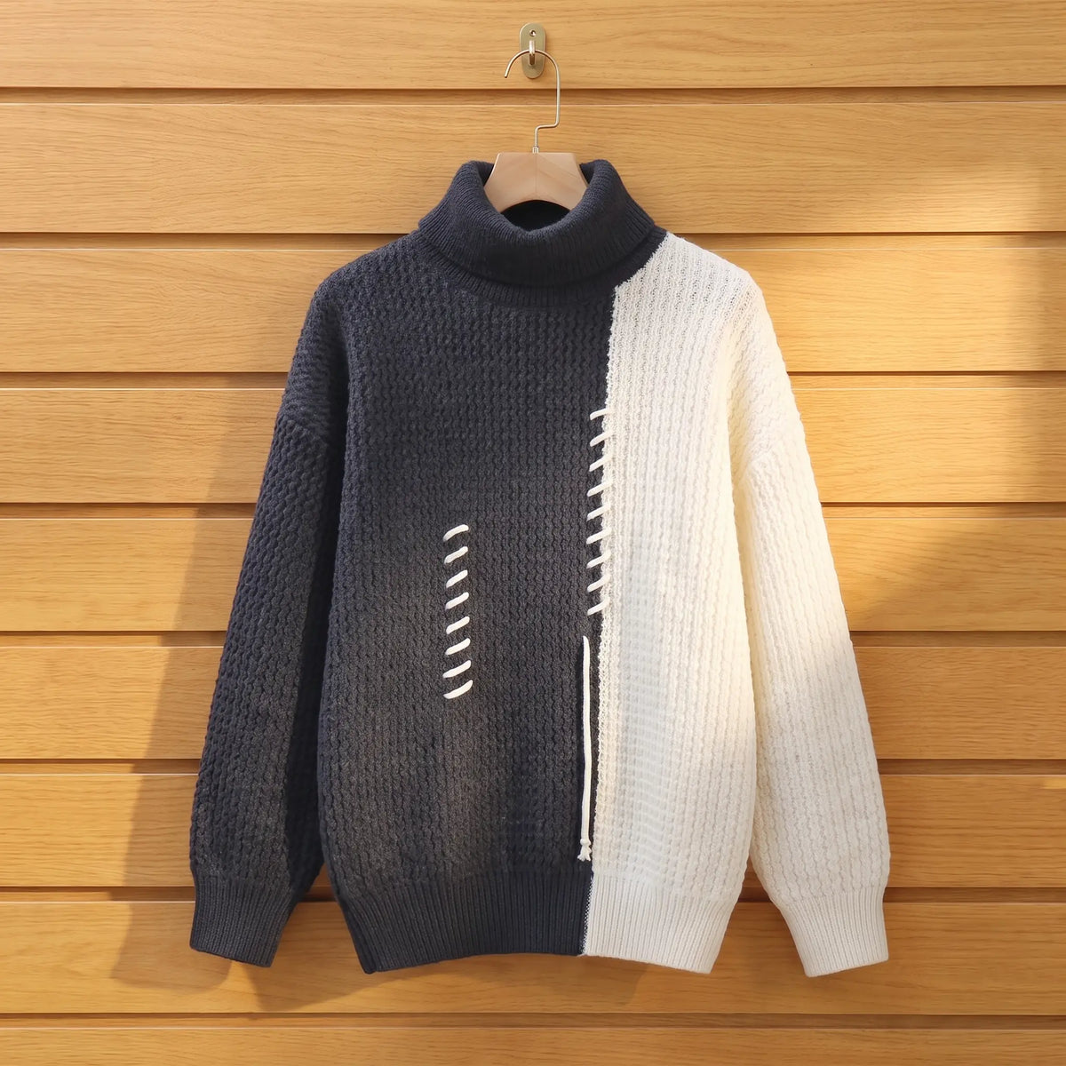 Men's grey and cream colour block knit turtleneck on a wooden hanger