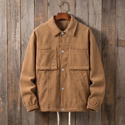 Men's brown corduroy work jacket with snap front and flap chest pockets on a wooden hanger