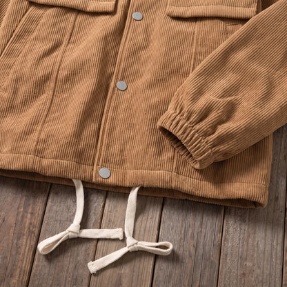 Close up of the elastic cuff and drawcord hem on the brown corduroy work jacket