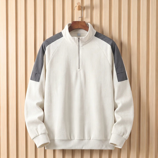 Men's white corduroy quarter-zip sweatshirt with grey shoulder panels on a wooden hanger