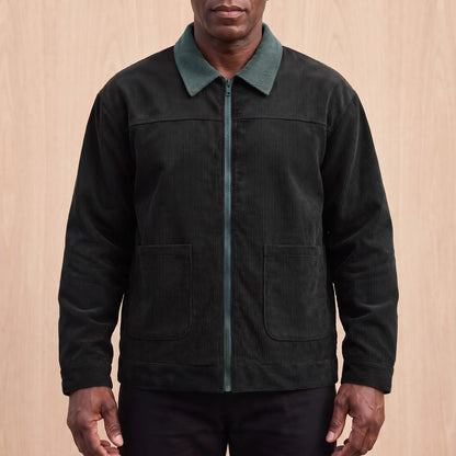 Men's black corduroy zip jacket with a green corduroy collar and two patch pockets, worn zipped