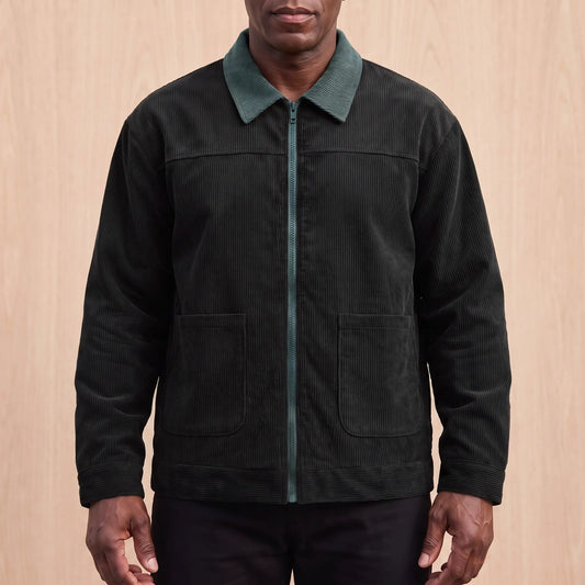 Men's black corduroy zip jacket with a green corduroy collar and two patch pockets, worn zipped