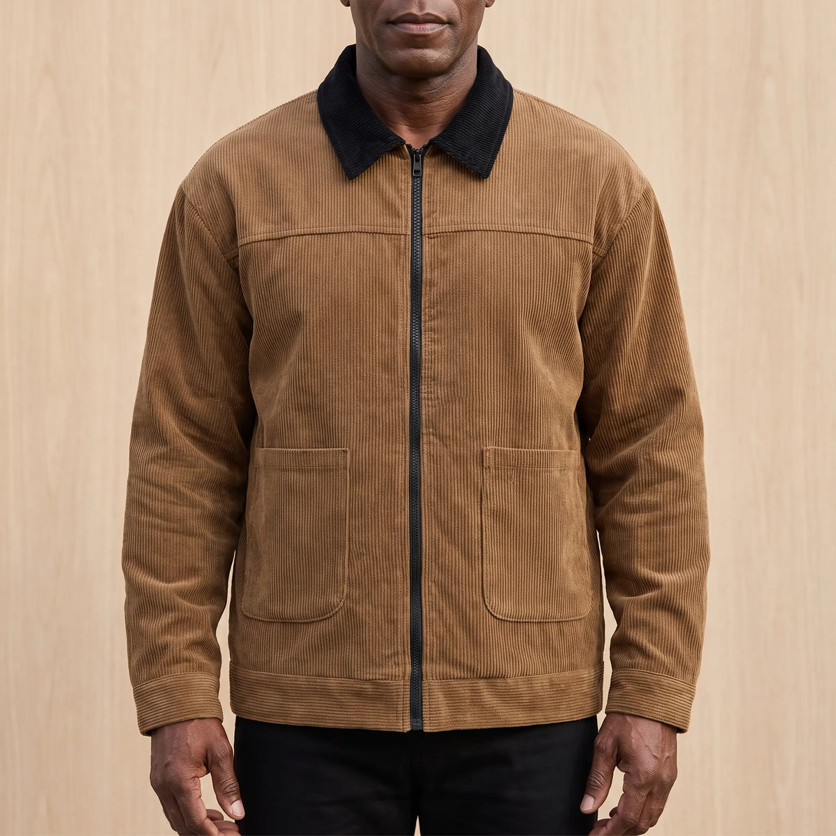 Men's brown corduroy zip jacket with a black corduroy collar and two patch pockets, worn zipped