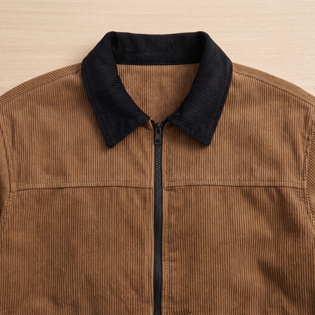 Close up of the contrast corduroy collar and zip on the brown cord collar jacket
