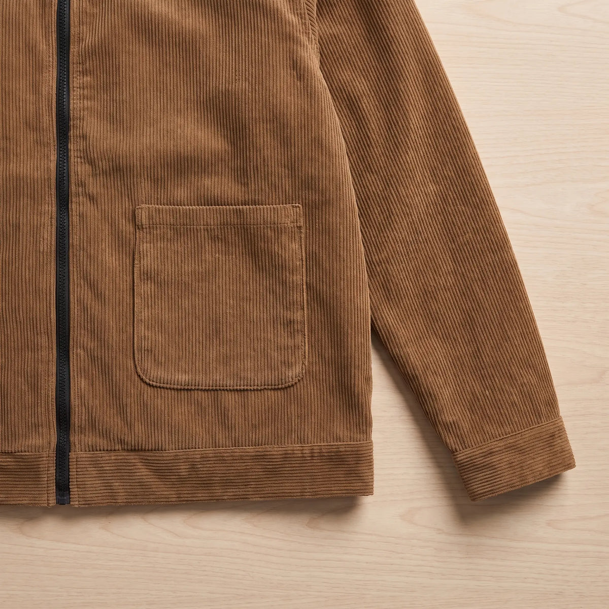 Close up of the patch pocket, cuff and hem on the brown cord collar jacket