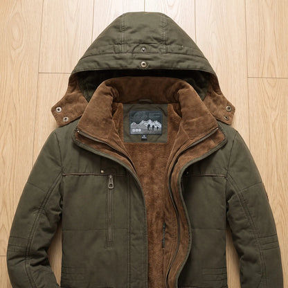 Flat-lay close-up of green parka hood, corduroy collar, fleece lining and zip chest pocket