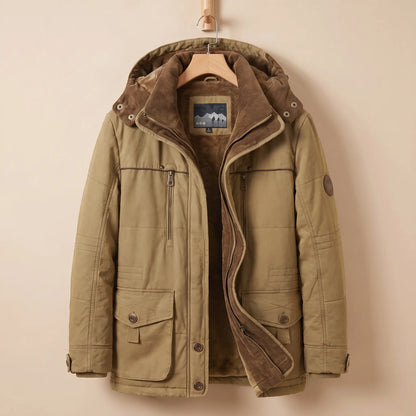 Men's khaki fleece-lined hooded parka with corduroy collar, zip chest pocket and snap flap pockets on a wooden hanger