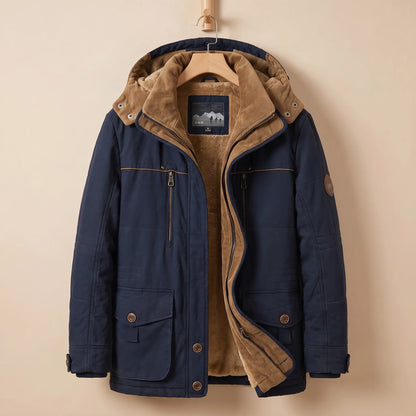 Men's navy blue fleece-lined hooded parka with corduroy collar, zip chest pocket and snap flap pockets on a wooden hanger
