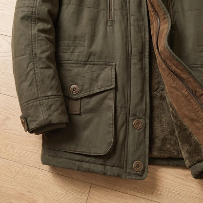 Flat-lay close-up of green parka snap flap pocket and snap cuff