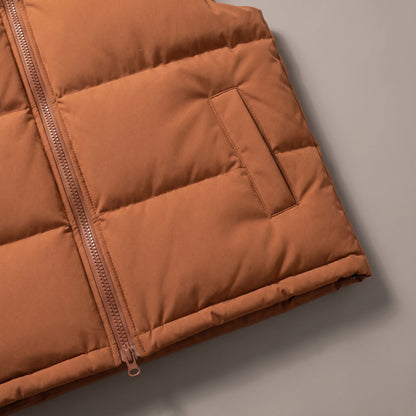 Close-up of the hand pocket, quilt channels and hem on the brown puffer vest