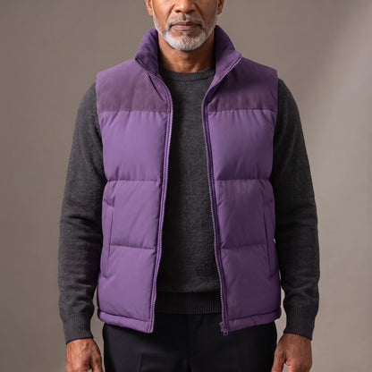 Men's purple quilted puffer vest with ribbed cord collar and shoulder yoke, worn open over a charcoal knit